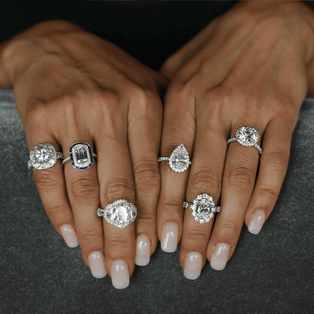 Engagement Rings Image featuring a woman's hands wearing engagement rings